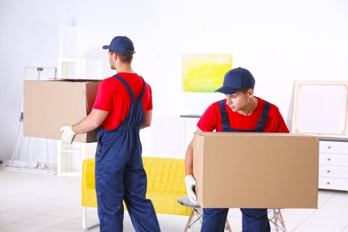 Removal team preparing a house move with boxes and furniture