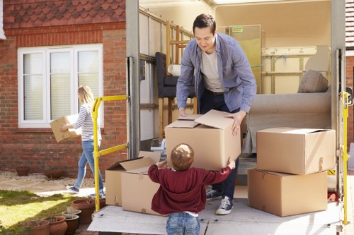 Local movers assisting with a house relocation in a residential street
