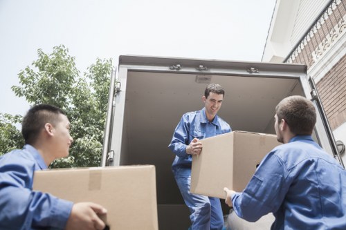 Local house removal team unloading boxes at a new property
