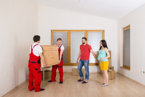 Boxes and furniture being loaded into a van for a house move