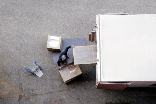 Professional movers loading household furniture into a van
