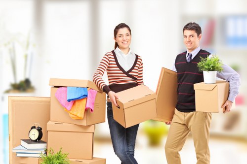 Removal team preparing a house move with boxes and furniture