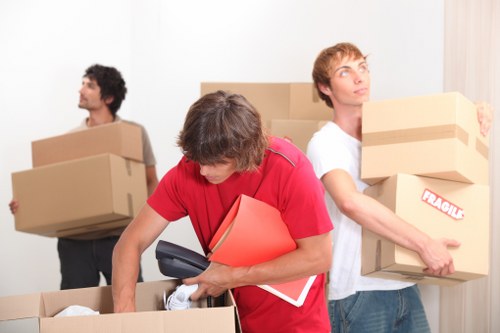 Movers carrying furniture through a narrow home entrance